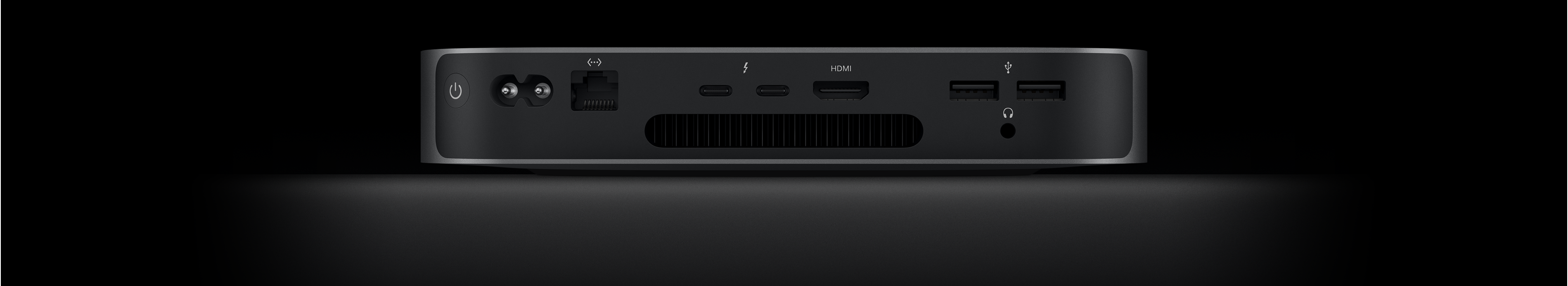 Vista posterior de una Mac mini que muestra dos puertos Thunderbolt 4, un puerto HDMI, dos puertos USB-A, una entrada para audífonos, un puerto Gigabit Ethernet, la entrada de alimentación y el botón de encendido.
